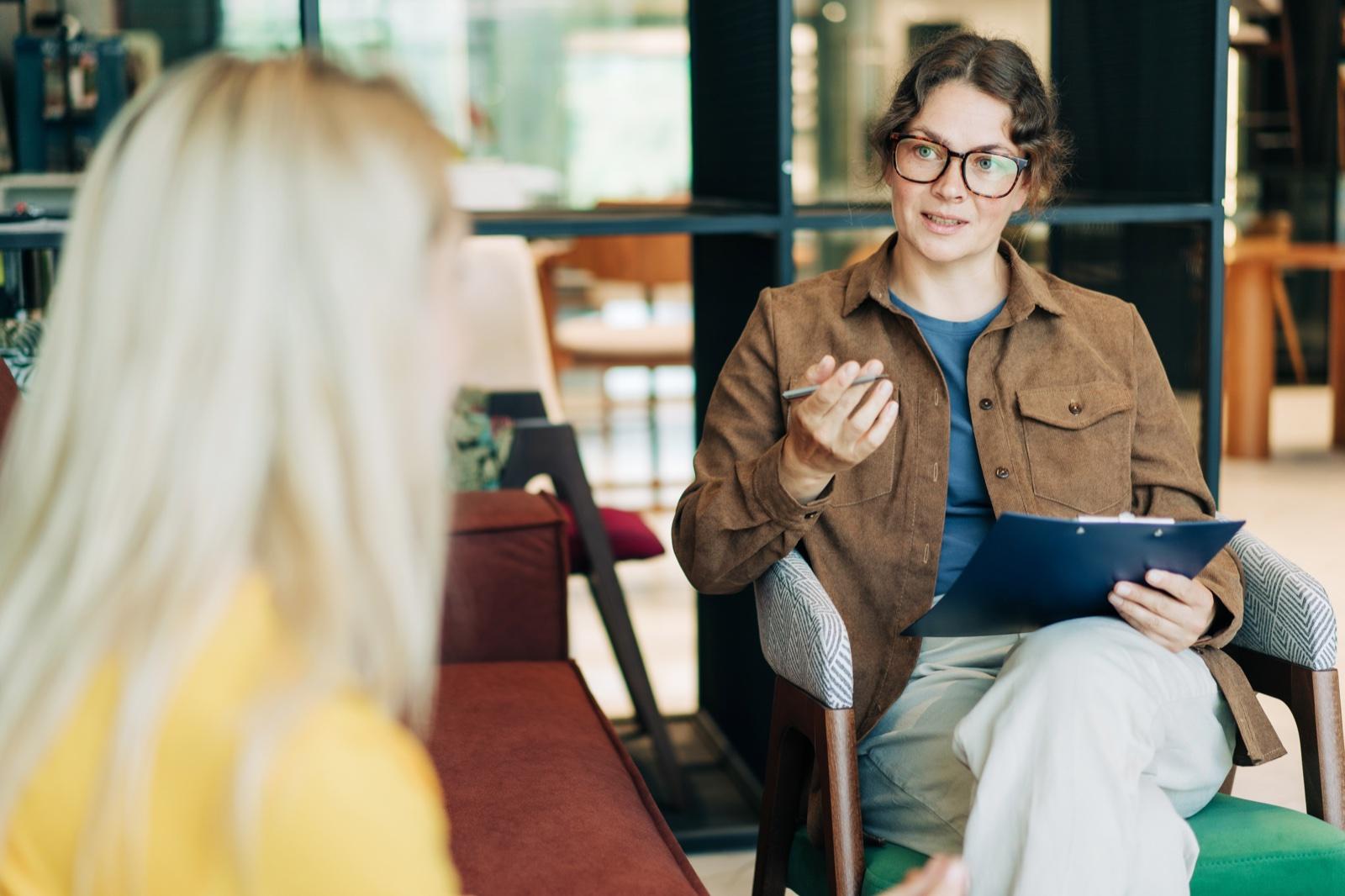 A registered psychologist in conversation with a client during a session